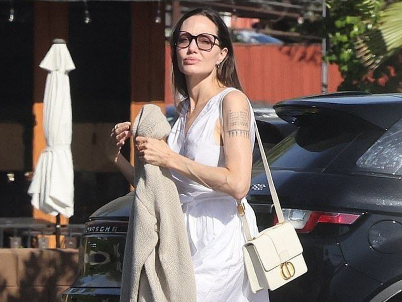 Angelina shows off subtle elegance as she steps out in chic white dress