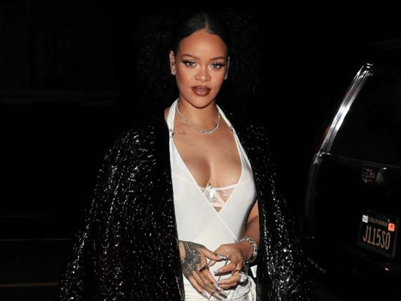 Rihanna shows off baby bump as she steps out for dinner with family